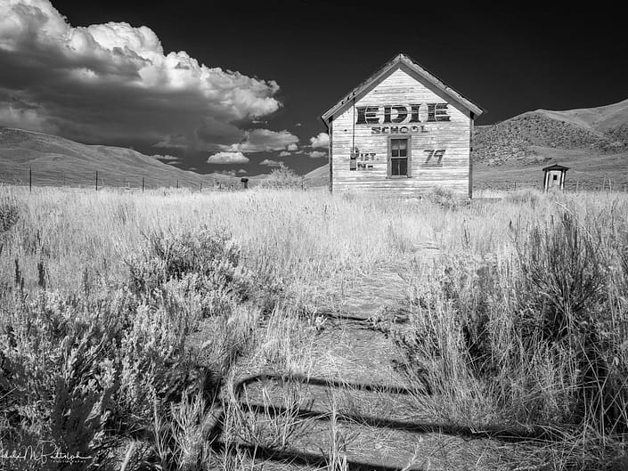 A black and white infrared photograph of Edie School shot on a back road in Idaho.