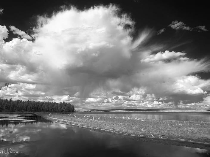 Black and white infrared image of Yellowstone Lake with dramatic clouds.